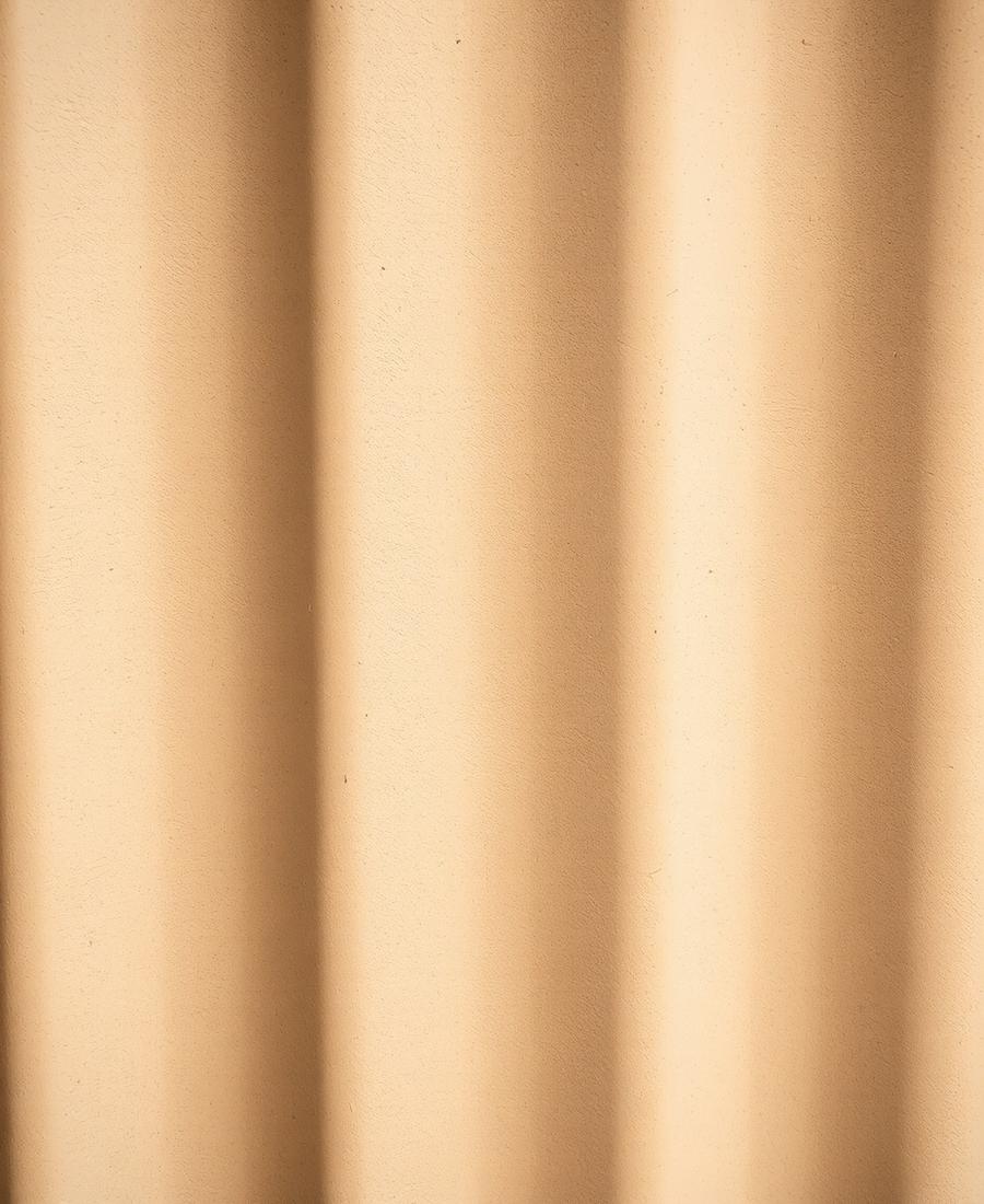 Abstract detail of a softly lit curved painted surface